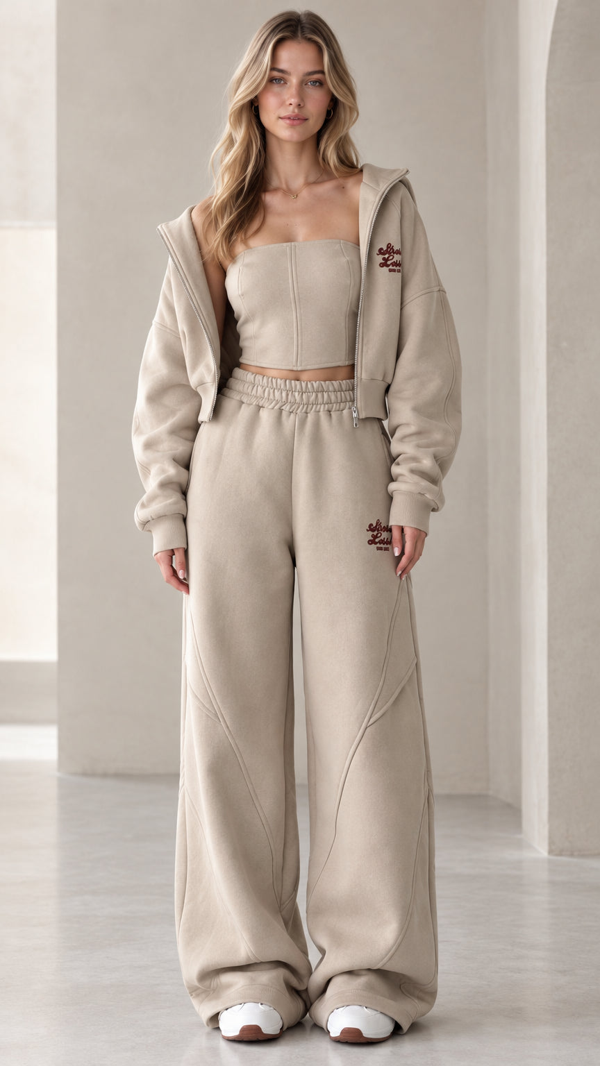 Front view of model wearing the oatmeal 3-piece cropped hoodie and wide-leg sweatpants set