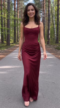 Front view of model wearing a burgundy square-neck corset maxi dress with ruched hips