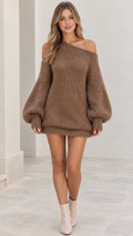 Front full-length view of model wearing mocha brown asymmetric off-shoulder knit sweater dress with balloon sleeves and cream boots