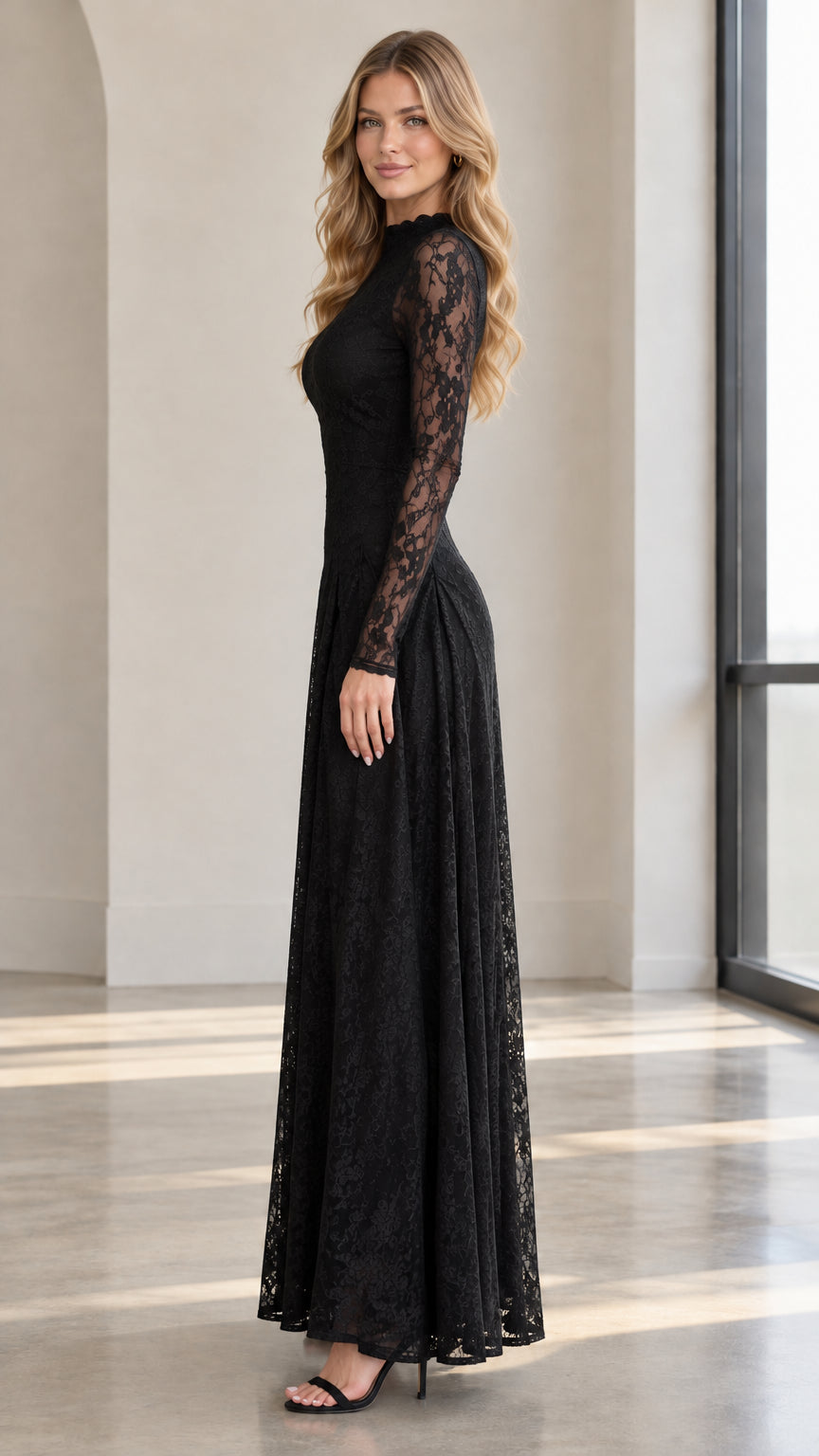 Side profile view of black long sleeve lace maxi gown with flowing skirt