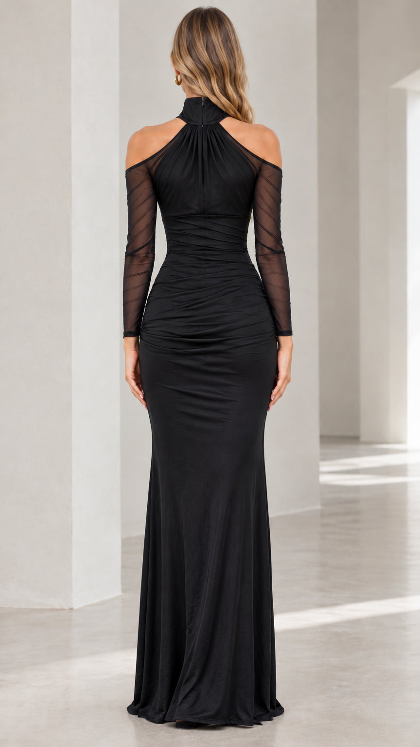 Back view of model in black high neck cold shoulder floor length gown