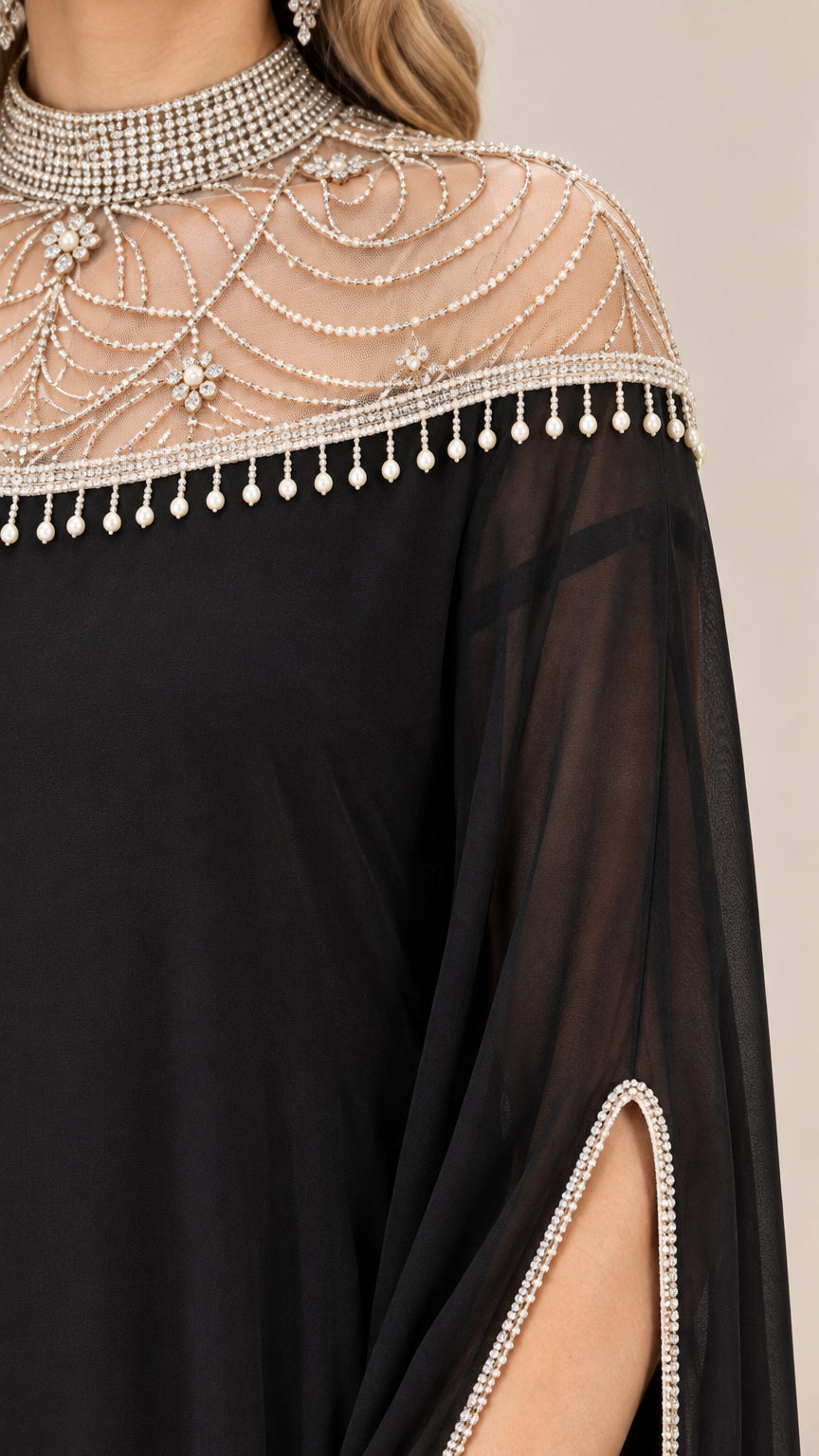 Close-up detail of sheer mesh illusion yoke with beaded swag and pearl fringe trim
